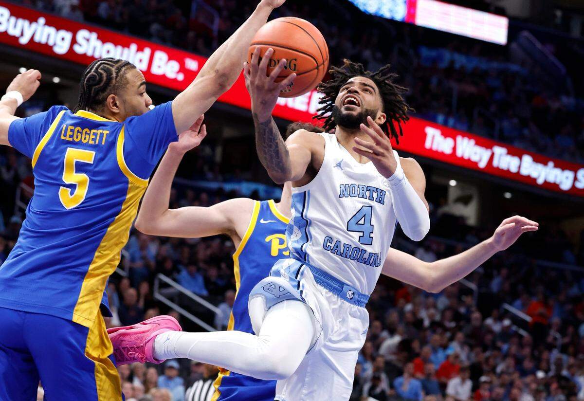 North Carolina’s RJ Davis (4) drives to the basket past Pittsburgh’s Ishmael Leggett (5) during the first half of UNC’s game against Pitt in the semifinals of the 2024 ACC Men’s Basketball Tournament at Capital One Arena in Washington, D.C., Friday, March 15, 2024.