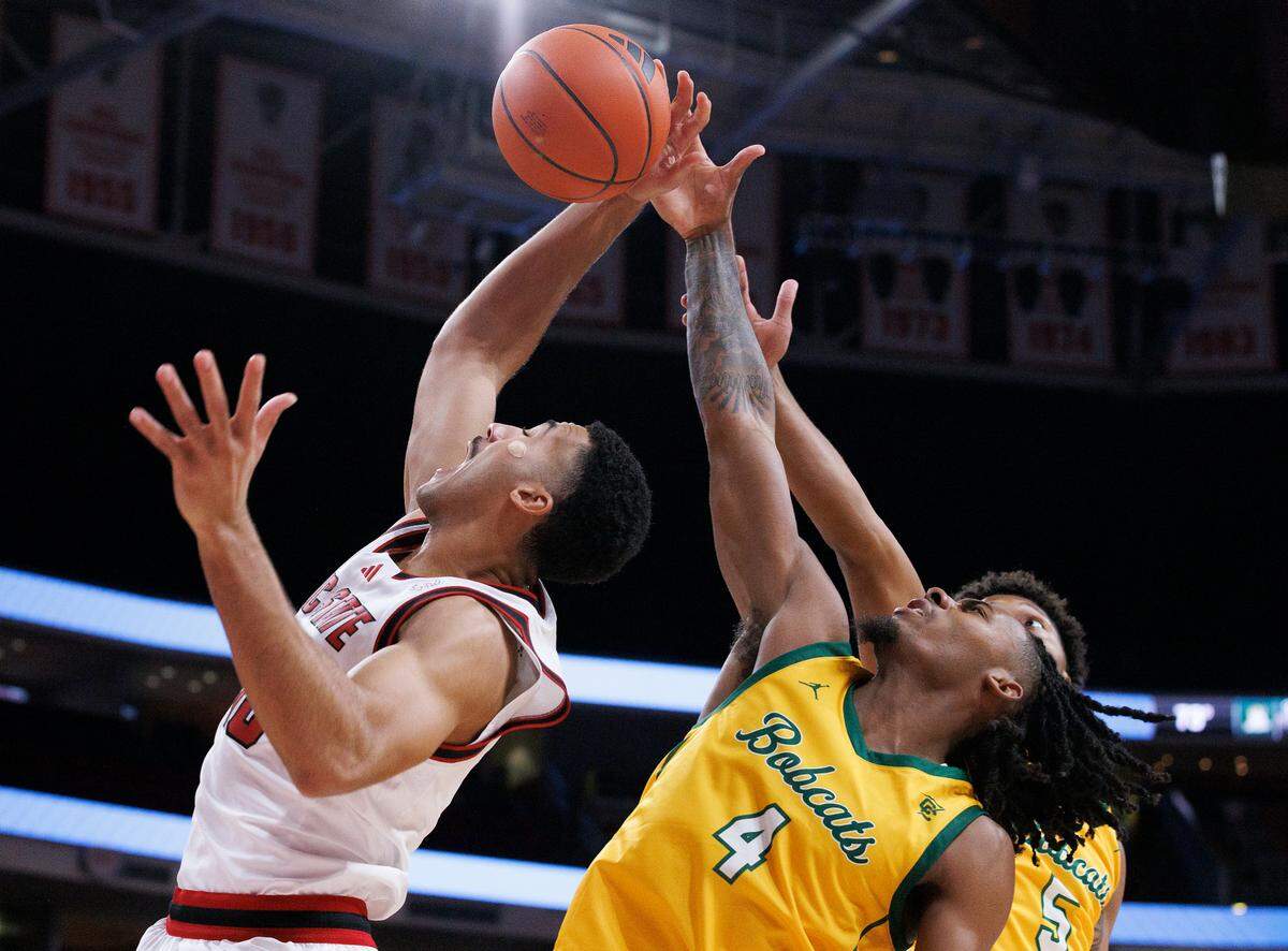 N.C. State’s Ismael Diouf grabs a rebound away from Lees-McRae’s Dre Nelson during the first half of the Wolfpack’s 79-75 exhibition win on Wednesday, Oct. 30, 2024, at the Lenovo Center.