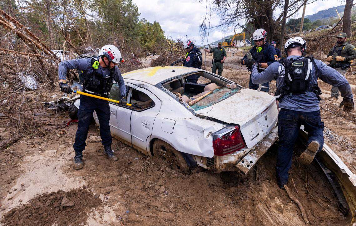 A FEMA search and rescue team from Maryland search for human remains in car in Swannanoa on Sunday, Oct. 6, 2024 after Tropical Storm Helene flooded the Swannanoa River. North Carolina officials have confirmed 76 deaths from Tropical Storm Helene.