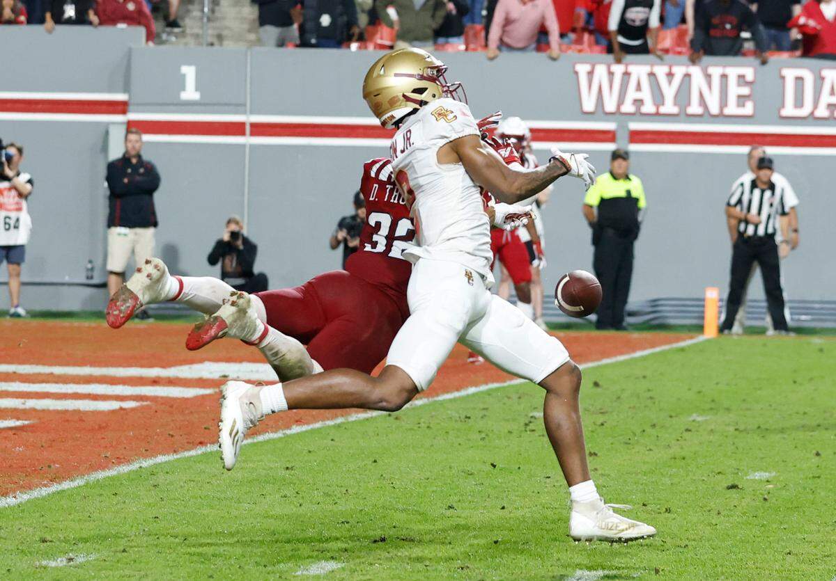 On fourth and six, N.C. State linebacker Drake Thomas (32) is called for pass interference as he defends Boston College wide receiver Joseph Griffin Jr. (2) late in the fourth quarter of Boston College’s 21-20 victory over N.C. State at Carter-Finley Stadium in Raleigh, N.C., Saturday, Nov. 12, 2022.