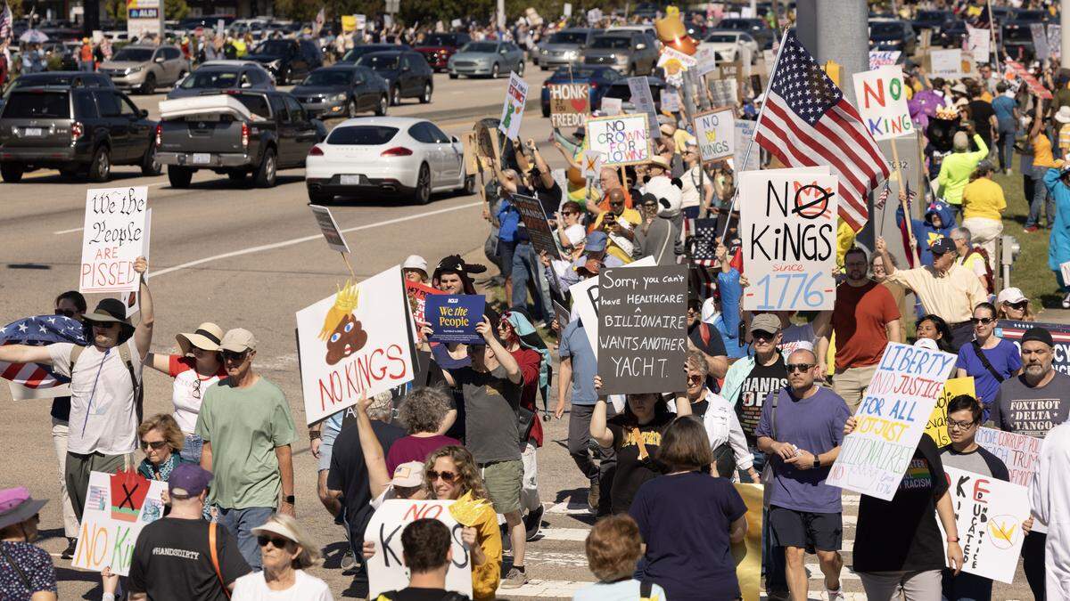 No Kings protesters line both sides of a section of Capital Blvd., Saturday, October 18, 2025.