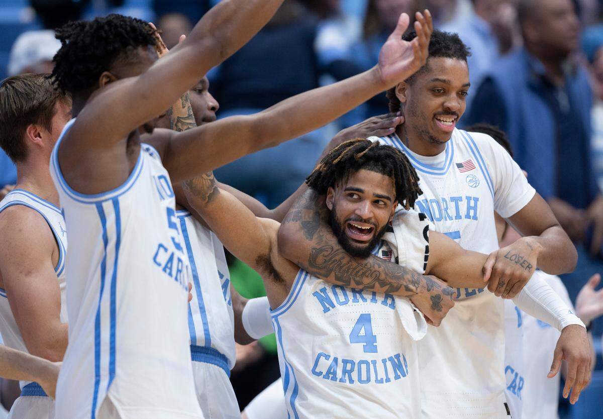 North Carolina’s Armando Bacot (5) embraces R.J. Davis (4) as they celebrate their 103-67 victory over Syracuse on Saturday, January 13, 204 at the Smith Center in Chapel Hill, N.C.