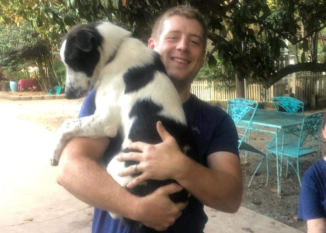 Nathan Mullins, a volunteer at Saving Grace Animals for Adoption in Wake Forest, holds a dog on Wednesday, Sept. 12 during the nonprofits’ drive to encourage pet fostering and adoption. Hurricane Florence is expected to bring strong winds and heavy rain to central North Carolina between September 13 and September 15.