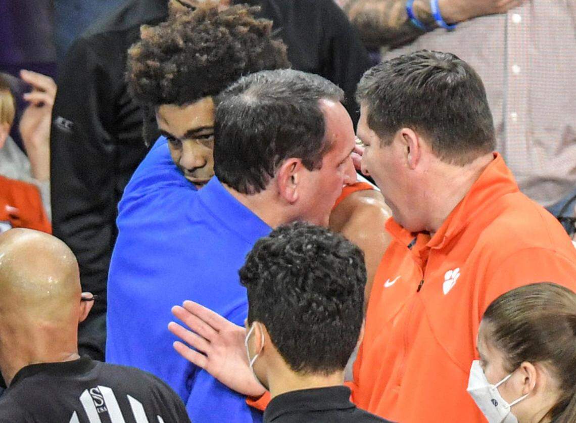 Clemson guard David Collins, left, hugs Duke coach Mike Krzyzewski, center, as Clemson coach Brad Brownell, right, looks on after Collins was ejected for fouling Duke’s Wendell Moore, Jr., during the first half of an NCAA college basketball game in Clemson, S.C., Thursday, Feb. 10, 2022. Duke beat Clemson 82-64. (Ken Ruinard/The Independent-Mail via AP)