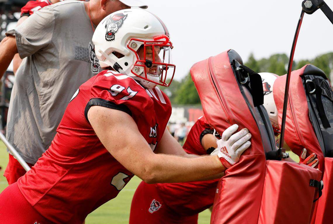 N.C. State defensive lineman Noah Potter (97) hits the pad during the Wolfpack’s first fall practice in Raleigh, N.C., Wednesday, August 2, 2023.