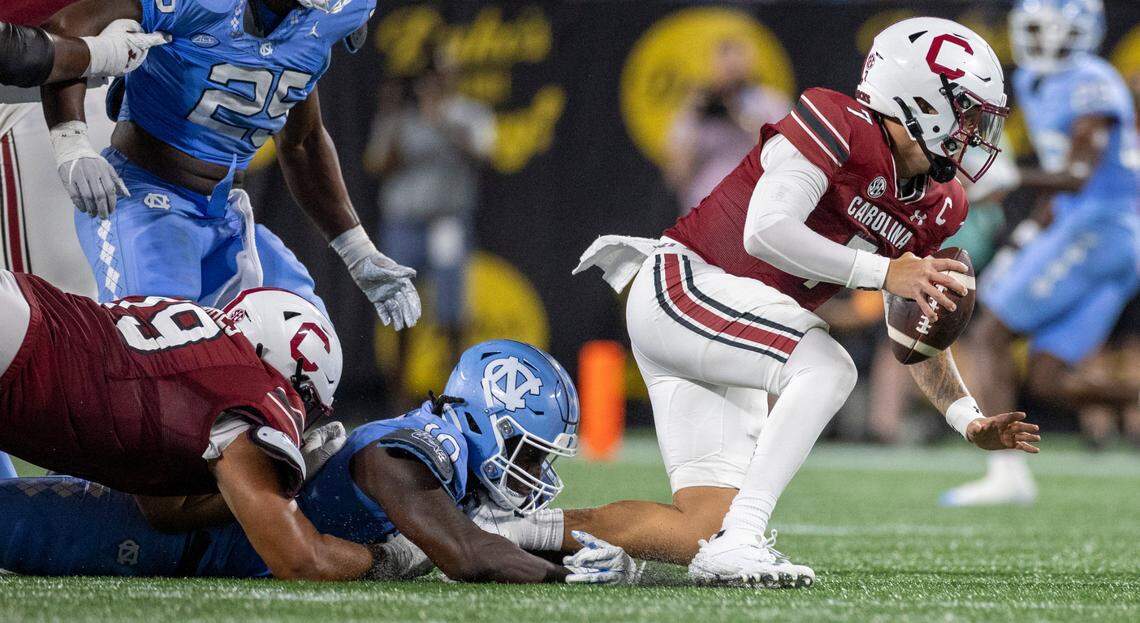 North Carolina’s Desmond Evans (10) sacks South Carolina quarterback Spencer Rattler (7) for a nine-yard loss in the third quarter on Saturday September 2, 2023 at Bank of America Stadium in Charlotte, N.C.