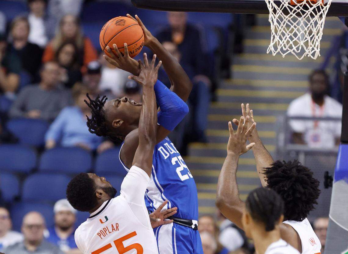 Duke’s Mark Mitchell (25) heads to the basket while Miami’s Wooga Poplar (55) defends during the first half of Duke’s game against Miami in the semifinals of the ACC Men’s Basketball Tournament in Greensboro, N.C., Friday, March 10, 2023.