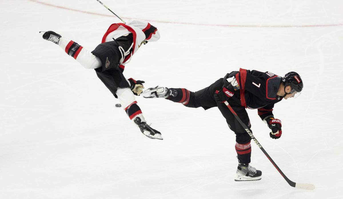 The Carolina Hurricanes Dmitry Orlov (7) hip checks Ottawa’s Mathieu Joseph during the third period on Wednesday, October 11, 2023 at PNC Arena, in Raleigh N.C.