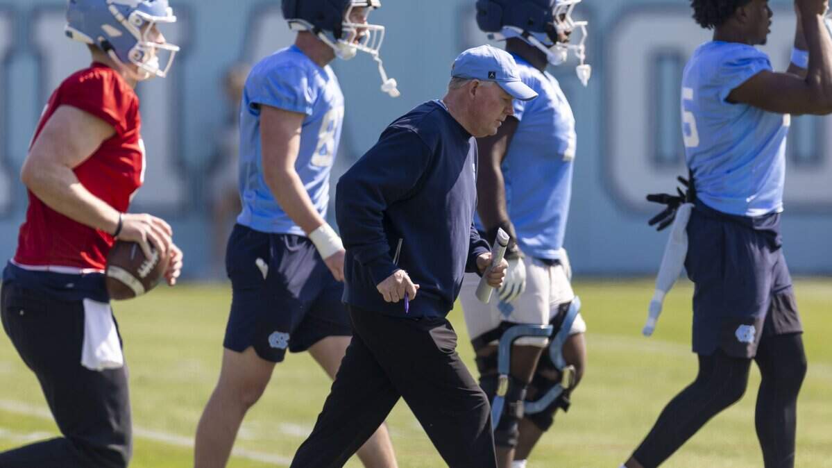 North Carolina offensive coordinator Bobby Petrino moves with players to their next drill station during the Tar Heels’ practice on Tuesday, March 24, 2026, at Kenan Stadium Chapel Hill, N.C.