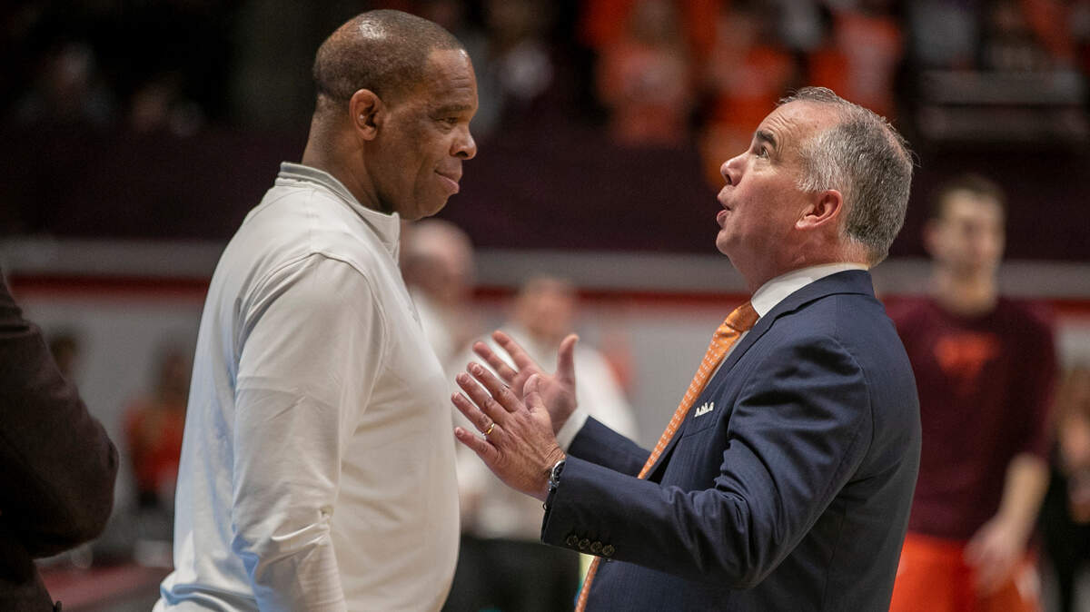 Virginia Tech coach Mike Young talks with North Carolina coach Hubert Davis prior to their game on Sunday, December 4, 2022 at Cassell Coliseum in Blacksburg, Va.