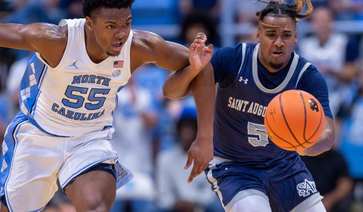 North Carolina’s Harrison Ingram (55) goes after the ball with St. Augustine’s Kaleb Glasser (5) in the first half on Friday, October 27, 2023 at the Smith Center in Chapel Hill, N.C.