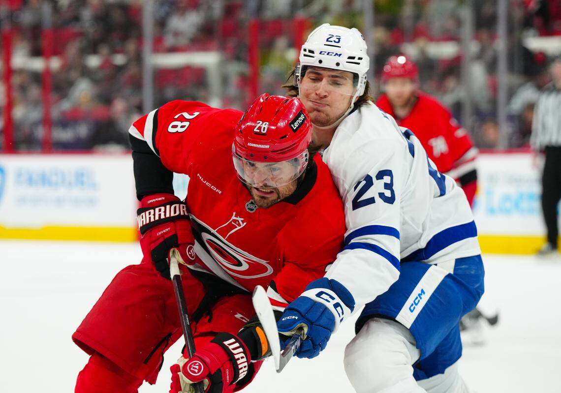 Carolina Hurricanes left wing William Carrier (28) and Toronto Maple Leafs left wing Matthew Knies (23) battle during the first period at Lenovo Center.