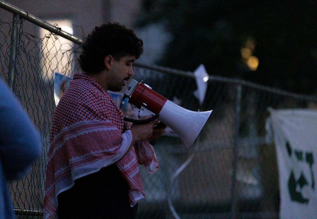 UNC-Chapel Hill graduate student Hashem Amireh speaks during a vigil held by the campus chapter of Students for Justice in Palestine on Monday, Oct. 7, 2024, in Chapel Hill, N.C. The vigil was intended to honor those who have been killed during Israel’s counter-campaign against Hamas in the past year.