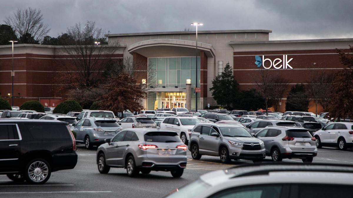 Cars drive through the parking lots at Southpoint Mall in Durham, N.C. on the evening of Sunday, Dec. 19, 2021 despite an afternoon report of gunfire. No injuries were reported.
