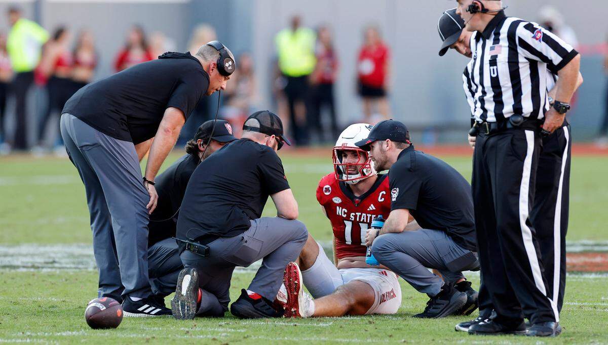 N.C. State head coach Dave Doeren and medical personnel check on linebacker Payton Wilson (11) after he was injured during the second half of N.C. State’s 24-17 victory over Clemson at Carter-Finley Stadium in Raleigh, N.C., Saturday, Oct. 28, 2023.