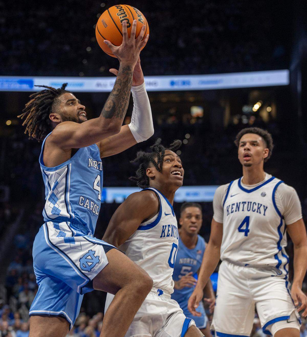 North Carolina’s R.J. Davis (4) drives to the basket against Kentucky’s Rob Dillingham (0) in the second half on Saturday, December 16, 2023 at State Farm Arena in Atlanta, Georgia. Davis lead all scores with 27 points.