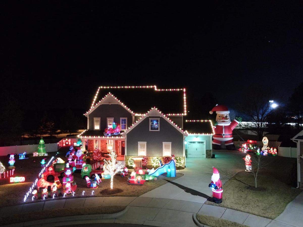 A 26-foot inflatable Santa greets visitors at this Knightdale light display.