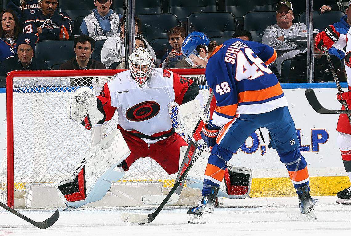 Goalie Brandon Bussi of the Carolina Hurricanes braces for a third period shot by Matthew Schaefer of the New York Islanders at UBS Arena on April 14, 2026 in Elmont, New York.