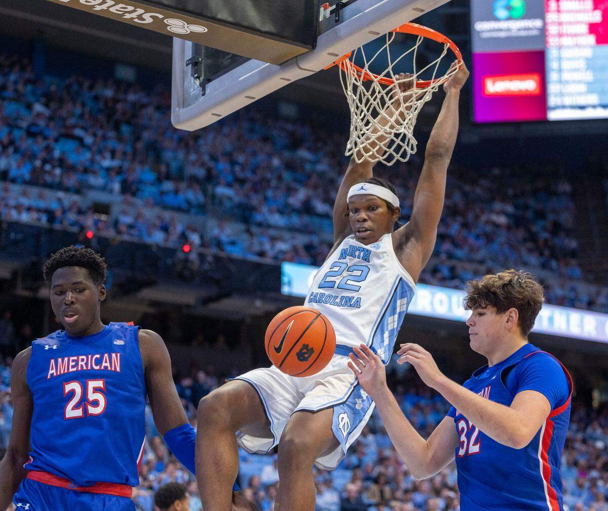 North Carolina forward Ven-Allen Lubin (22) gets a dunk over American University’s Julen Iturbe (32) and Eric Michaels (25) in the first half on Friday, November 15, 2024 at the Smith Center in Chapel Hill, N.C.