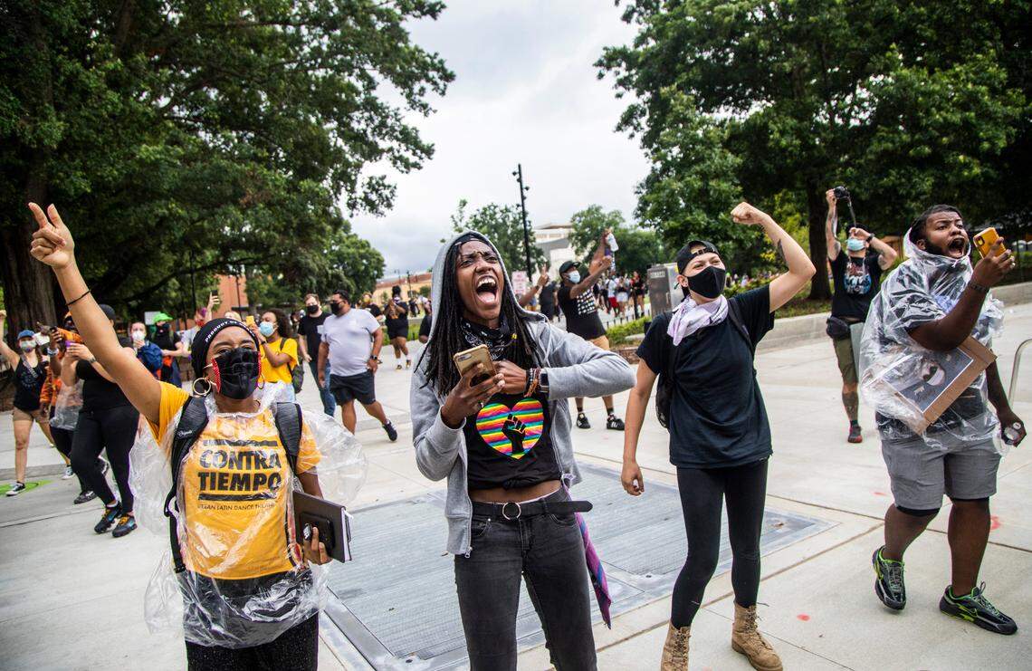People cheer as Black Lives Matter demonstrators ride on horseback through downtown Raleigh Friday, June 19, 2020 in recognition of Juneteenth.