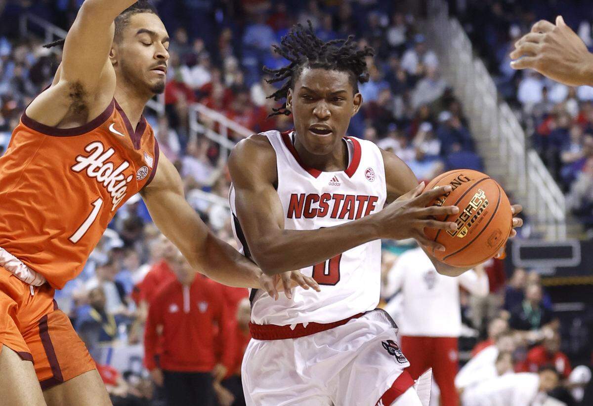 N.C. State’s Terquavion Smith (0) drives around Virginia Tech’s Rodney Rice (1) during the first half of N.C. State’s game against Virginia Tech in the second round of the ACC Men’s Basketball Tournament in Greensboro, N.C., Wednesday, March 8, 2023.