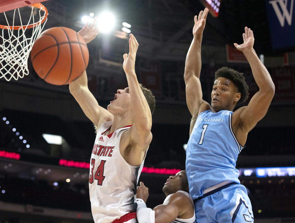 N.C. State’s Ben Middlebrooks (34) drives to the basket past the Citadel’s AJ Smith during the first half of the Wolfpack’s season opener against The Citadel on Monday, Nov. 6, 2023, at PNC Arena in Raleigh, N.C.