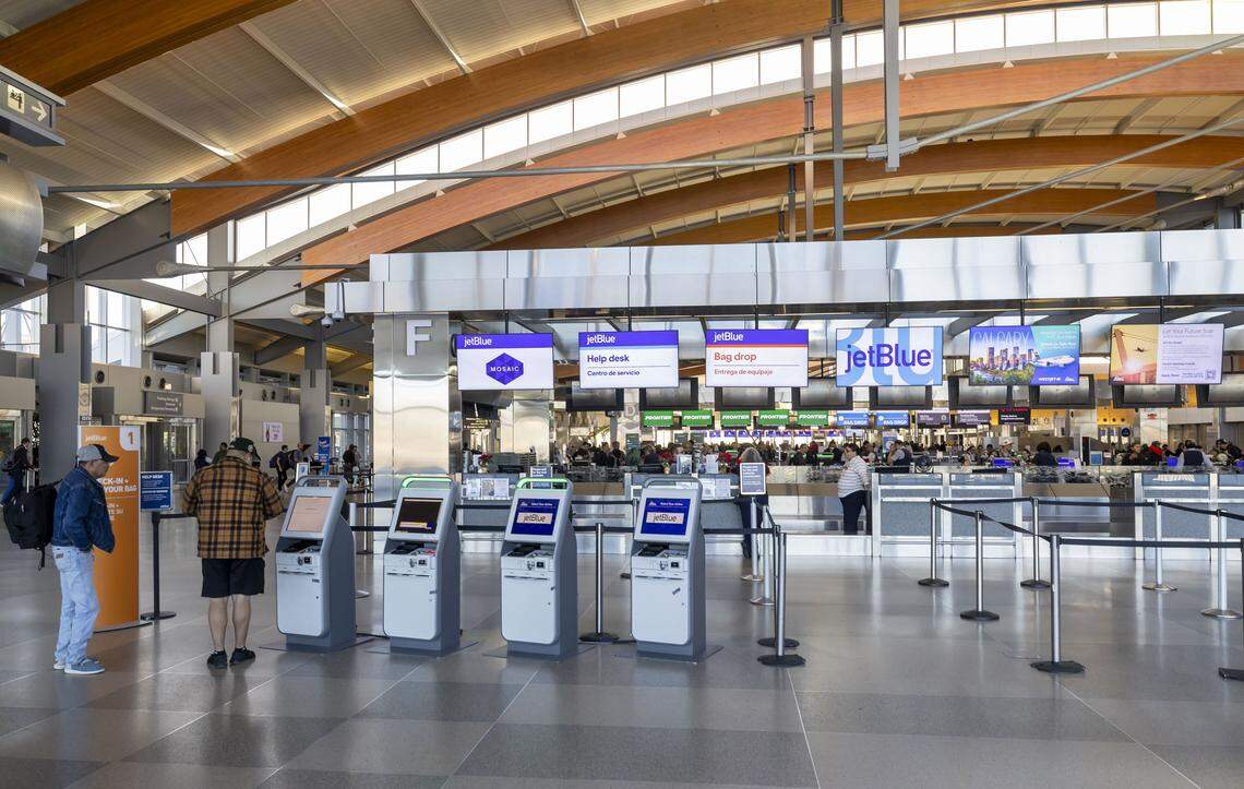 Passengers use kiosks to check in for their flights inside Terminal 2 at RDU International airport on Friday, December 19, 2025 in Morrisville, N.C. 