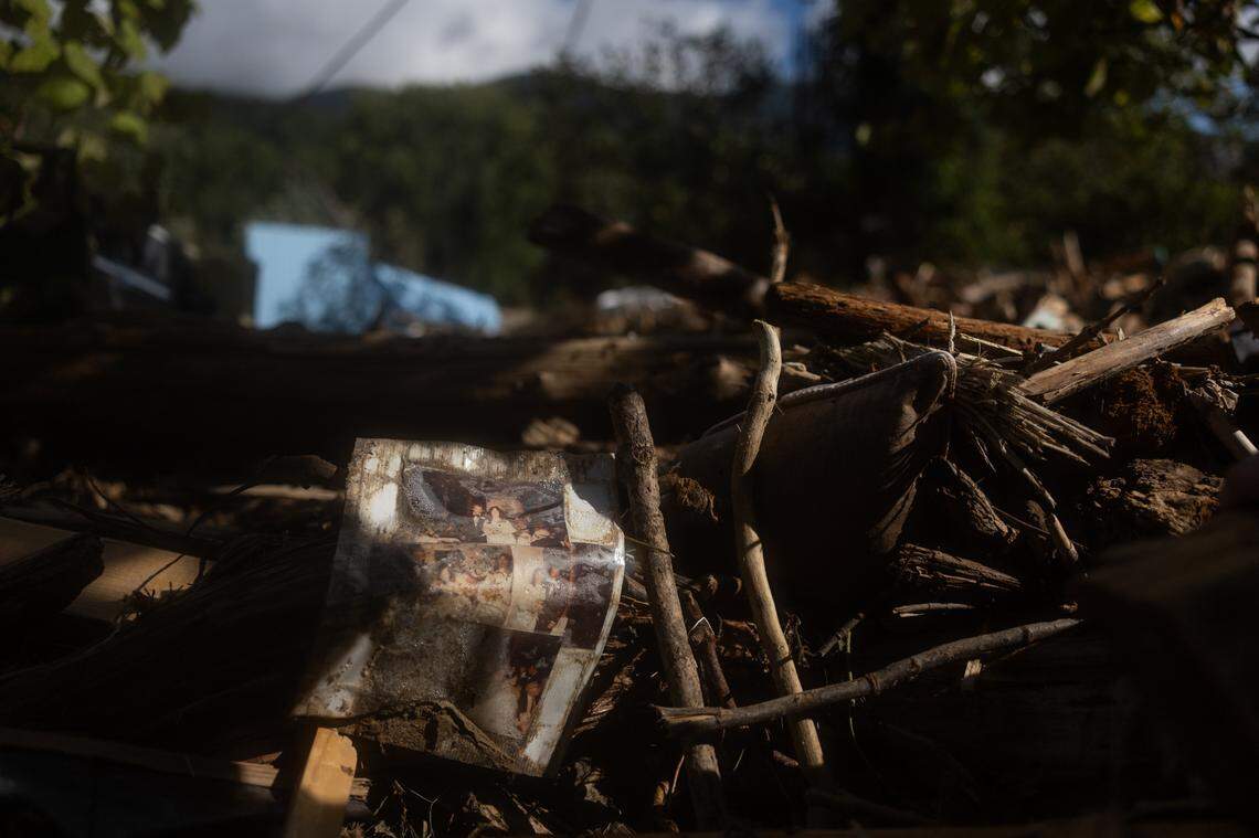 A collage of wedding photos sits onto of rubble in Lake Lure, N.C. on Sunday, September 29, 2024.