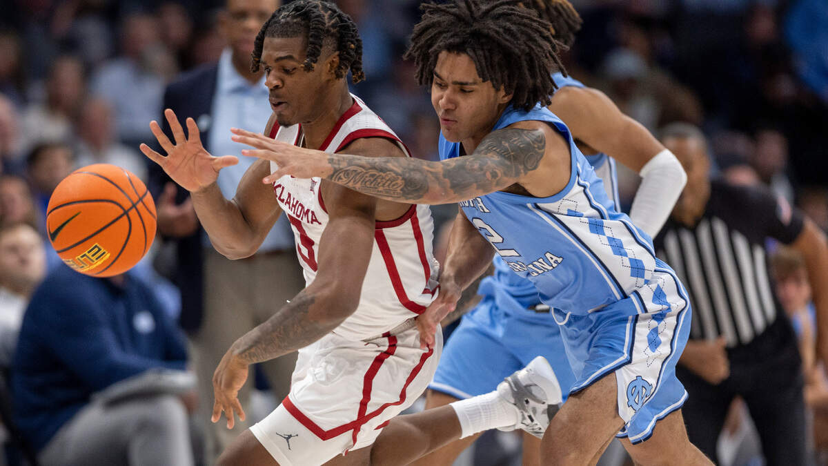 North Carolina’s Elliot Cadeau (2) works for a steal from Oklahoma’s Otega Oweh (3) in the second half on Wednesday, December 20, 2023 at the Spectrum Center in Charlotte, N.C.