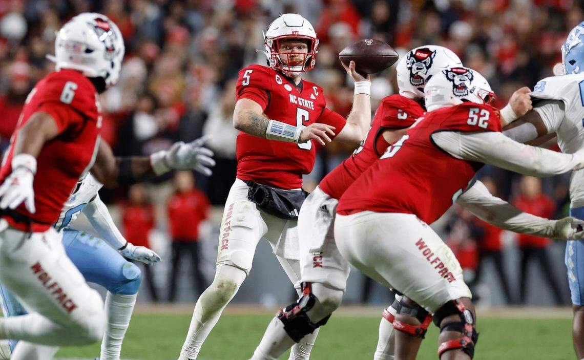 N.C. State quarterback Brennan Armstrong (5) prepares to pass during the first half of N.C. State’s game against UNC at Carter-Finley Stadium in Raleigh, N.C., Saturday, Nov. 25, 2023.