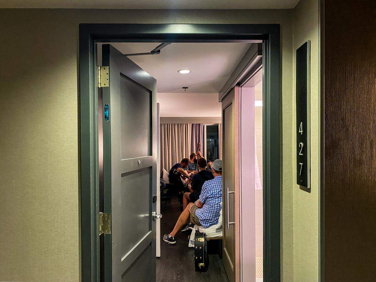 With the door wide open, a group of musicians casually gathered for a “jam session” at 2 a.m. in room number 427 of the Marriott Raleigh City Center hotel after the last night of the IBMA World of Bluegrass Live! festival in downtown Raleigh on October 3, 2021.