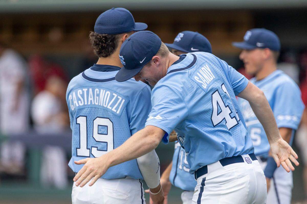 North Carolinas Will Sandy (41) gives teammate Johnny Castagnozzi (19) a pat on the back at the first end of the first inning, after holding Arkansas scoreless on Sunday, June 12, 2022 at Boshamer Stadium in Chapel Hill, N.C.