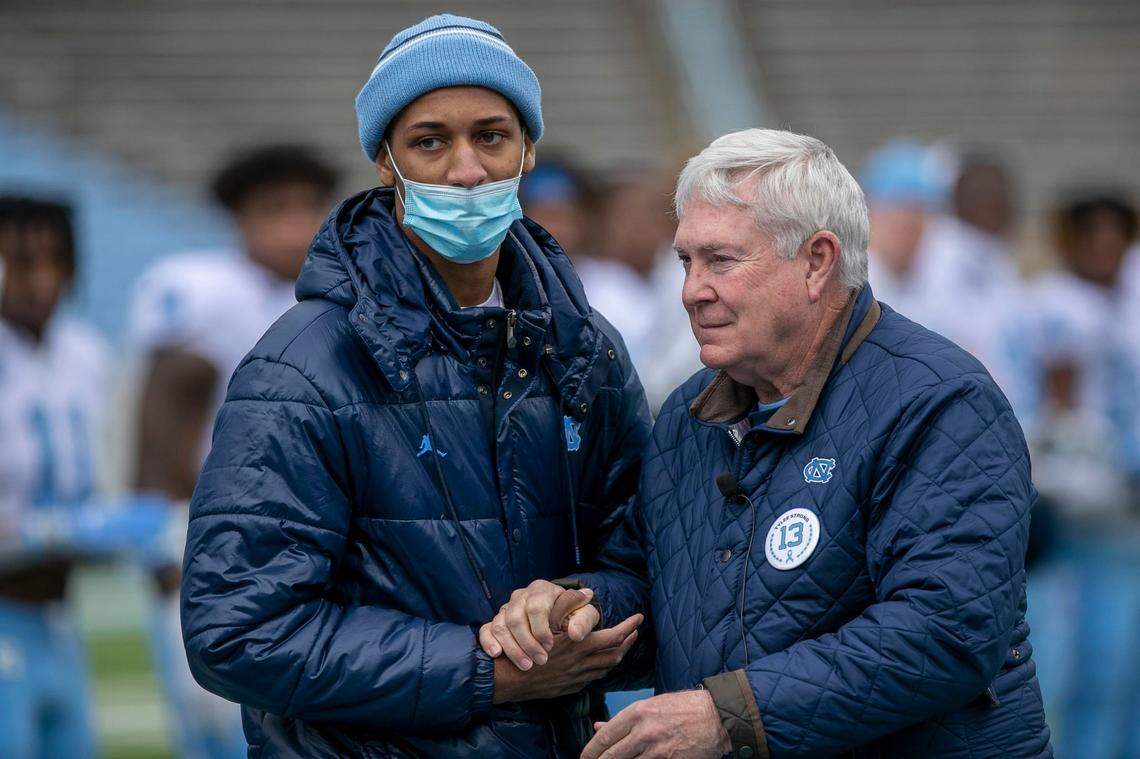 North Carolina coach Mack Brown embraces wide receiver Tylee Craft, who was recently diagnosed with a rare form of cancer, prior to the Tar Heels’ spring football game on Saturday, April 9, 2022 at Kenan Stadium in Chapel Hill, N.C.