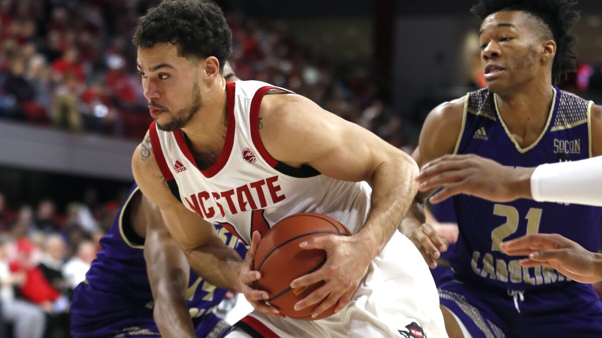 N.C. State’s Devon Daniels (24) drives past Western Carolina’s Marcus Thomas (21) during the first half of N.C. State’s game against Western Carolina at Valvano Arena at Reynolds Coliseum in Raleigh, N.C., Wednesday, Dec. 5, 2018.