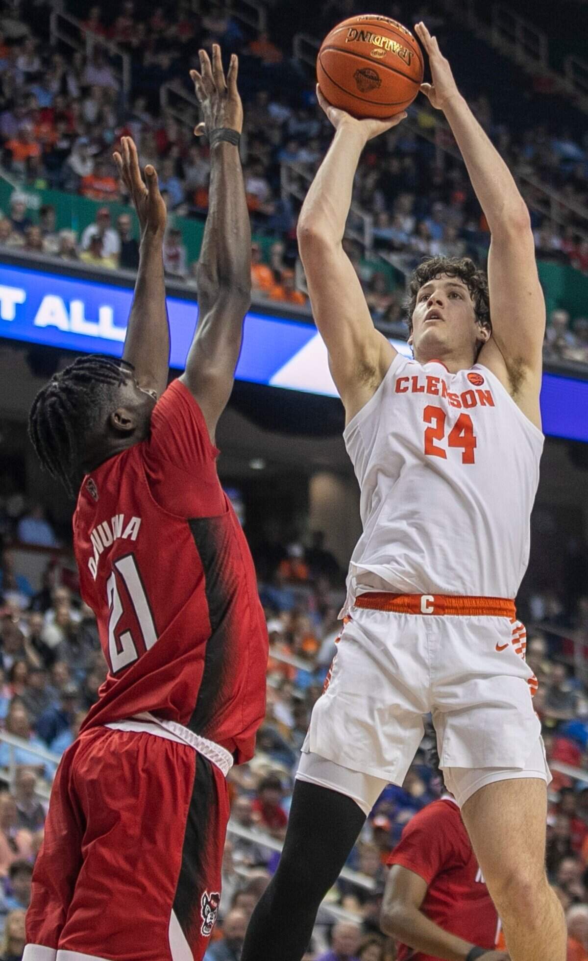 Clemson’s P.J. Hall (24) puts up a shot against N.C. State’s Ebenezer Dowuona (21) in the first half during the third round of the ACC Tournament on Thursday, March 9, 2023 at the Greensboro Coliseum in Greensboro, N.C.