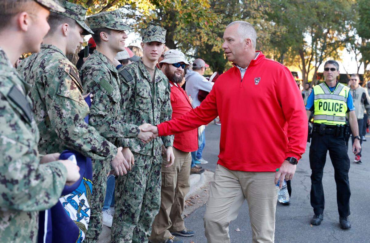 N.C. State head coach Dave Doeren greets N.C. State ROTC members, thanking each one for their service, during the Walk of Champions before the Wolfpack’s game against Miami at Carter-Finley Stadium in Raleigh, N.C., Saturday, Nov. 4, 2023.