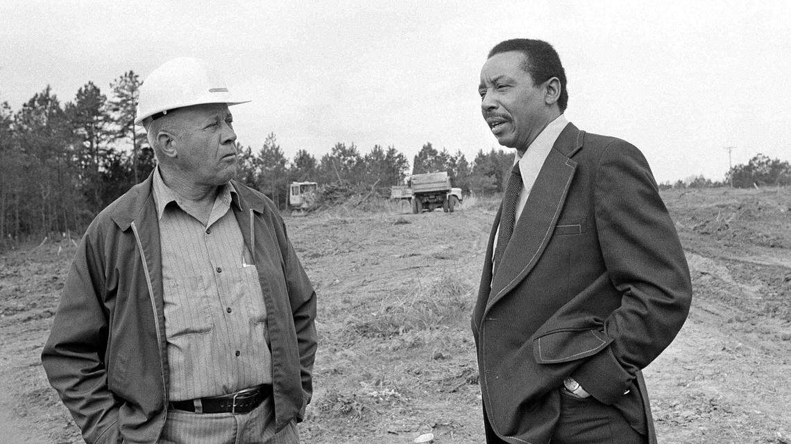 In this 1974 file photo, former civil rights lawyer-activist Floyd McKissick, right, talks to grade foreman A.T. Ayscue, in the empty fields where the future “Soul City” was to be built in Warren County, N.C., June 20, 1974.