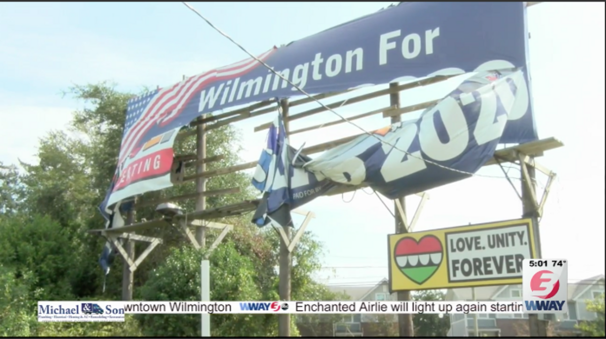Four activists in North Carolina turned themselves in Tuesday on charges of vandalizing a “Wilmington for Trump” billboard earlier this month, police said.