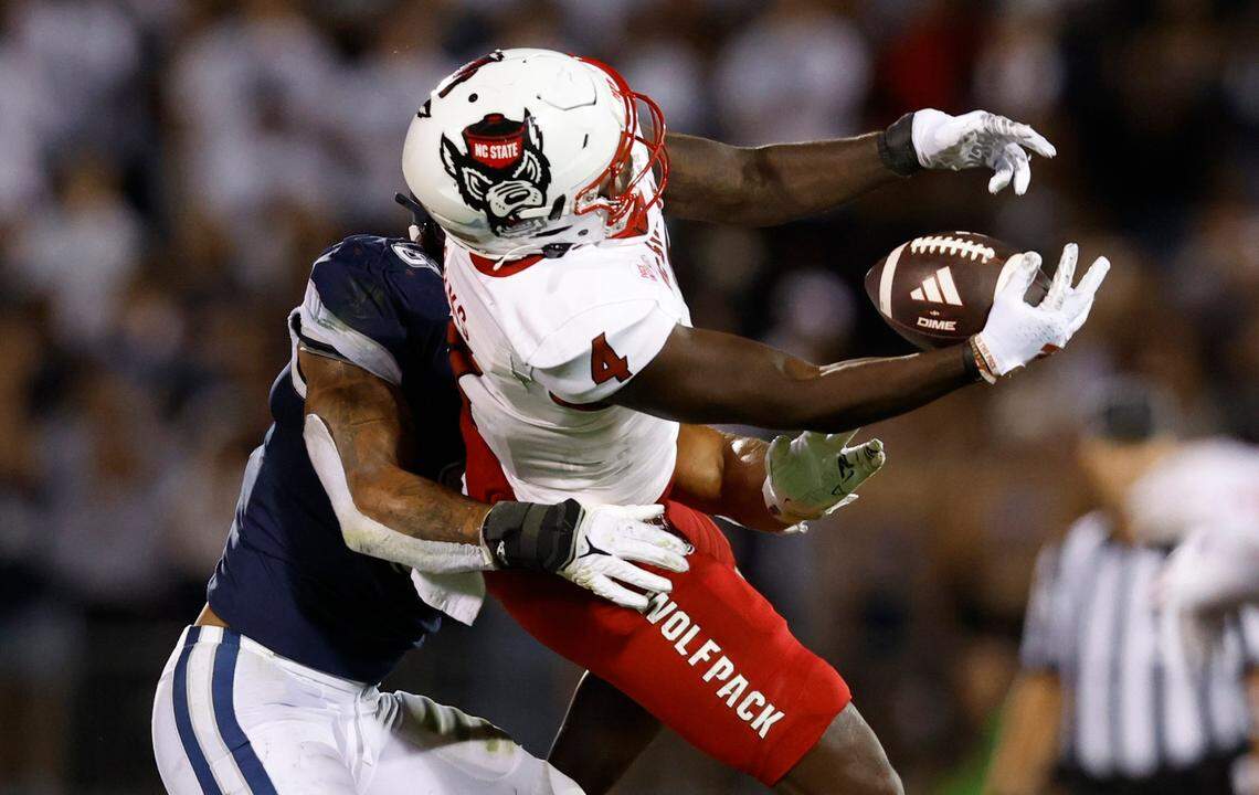 N.C. State wide receiver Julian Gray (8) pulls in the reception while defended by Connecticut linebacker Jackson Mitchell (8) during the first half of N.C. State’s game against UConn at Rentschler Field in East Hartford, Conn. Thursday, August 31, 2023.