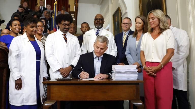 NC budget with year-delayed raises is now law. Gov. Stein signs spending plan
