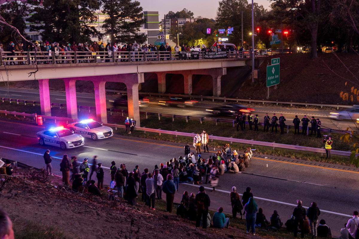 Protesters block the northbound lanes of the Durham Freeway at the South Magnum Street bridge for hours Thursday evening, Nov. 2, 2023 while demanding a ceasefire in the Israel-Gaza War as police warned of arrests.