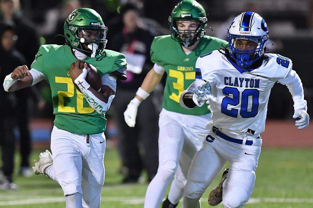 Cardinal Gibbons running back Aaron Anderson (28) runs for the touchdown against Clayton defensive back Malachi Burt (20) during the second half. The Clayton Comets and the Cardinal Gibbons Crusaders met in the East Regional Final of the NCHSAA 7A Football Championship in Clayton, N.C. on December 4, 2025.