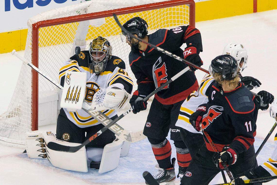 Boston Bruins goaltender Jaroslav Halak (41) eyes the puck in front of Carolina Hurricanes’ Vincent Trocheck (16) as Hurricanes’ Jordan Staal (11) looks on during third period NHL Eastern Conference Stanley Cup playoff game in Toronto on Saturday, Aug. 15, 2020. (Chris Young/The Canadian Press via AP)