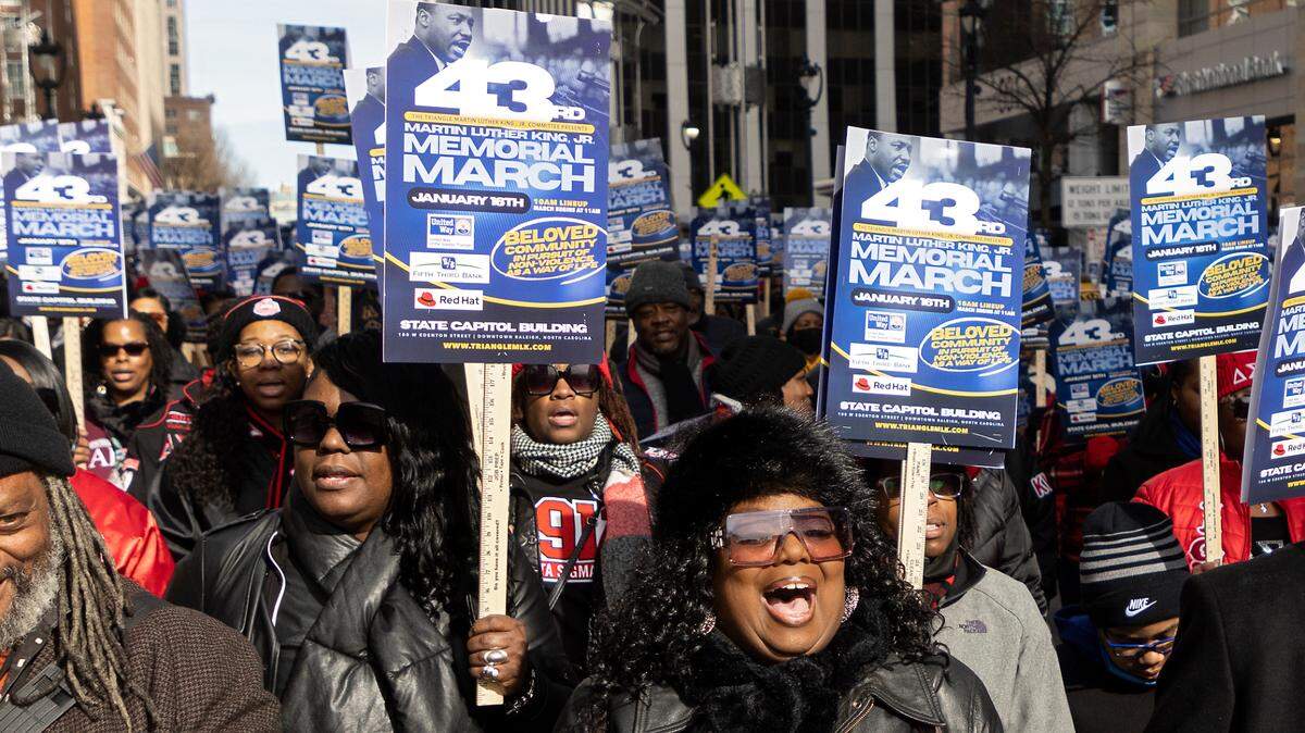 Angela Smith Kent, center, sings during the Martin Luther King, Jr. Memorial March on Monday, Jan. 16, 2023, in Raleigh, N.C.