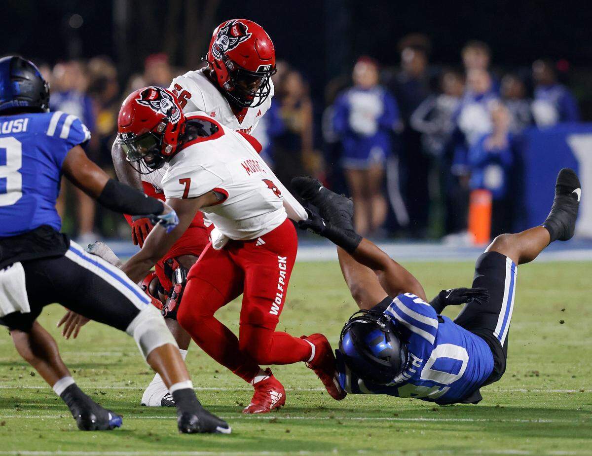 Duke’s Ryan Smith tackles N.C. State’s MJ Morris during the first half of the Blue Devils’ game on Saturday, Oct. 14, 2023, at Wallace Wade Stadium in Durham, N.C.