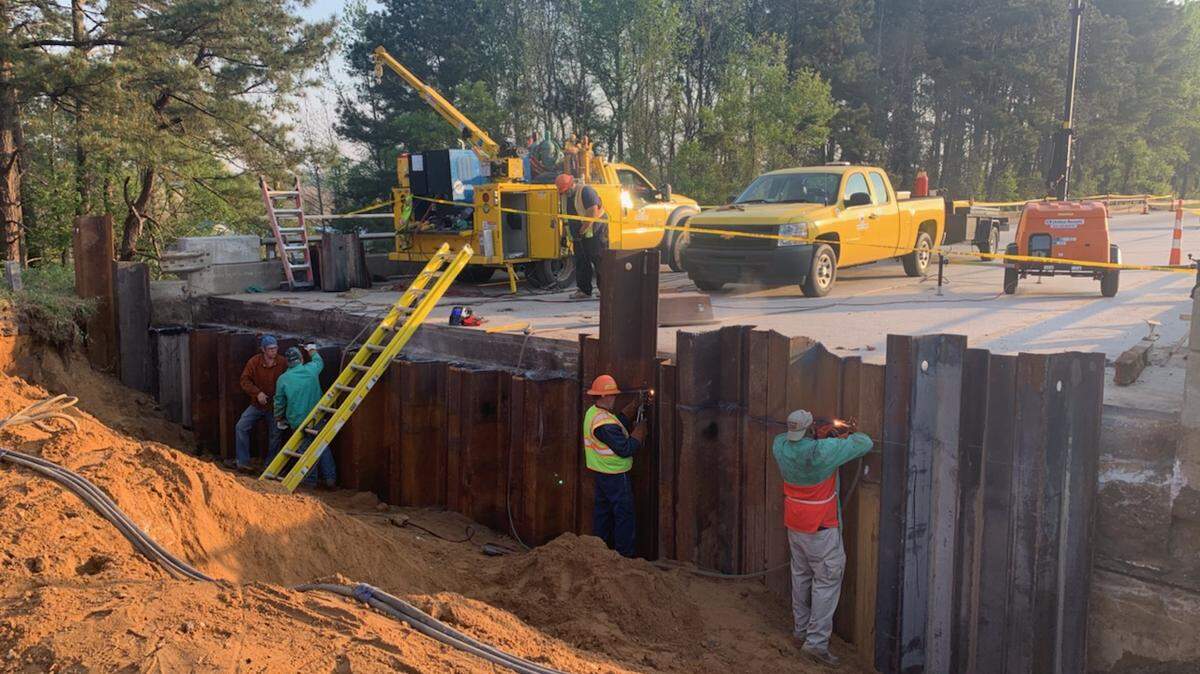 N.C. Department of Transportation workers install steel sheeting at the base of the southbound Interstate 95 bridge over Boyce Road in Robeson County. A void or cavity developed under the pavement in front of the bridge, requiring emergency repairs that have closed a three-mile stretch of the highway.
