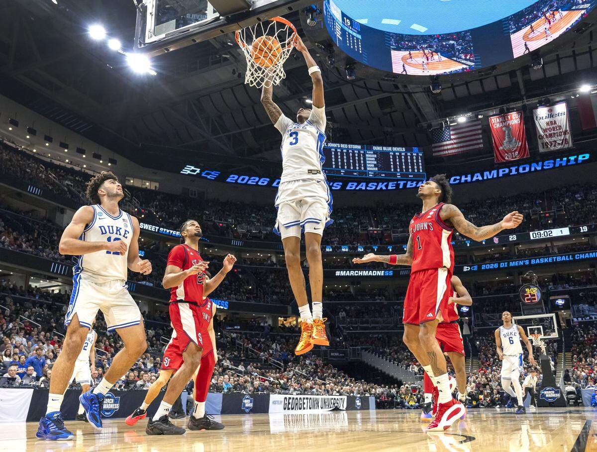 Duke forward Isaiah Evans (3) breaks to the basket for a dunk in the first half against St. John’s during the Sweet Sixteen of the NCAA Tournament on Friday, March 27, 2026, at Capital One Arena in Washington, D.C.  Evans lead all scores with 25 points in the Blue Devils’ 80-75 victory. 