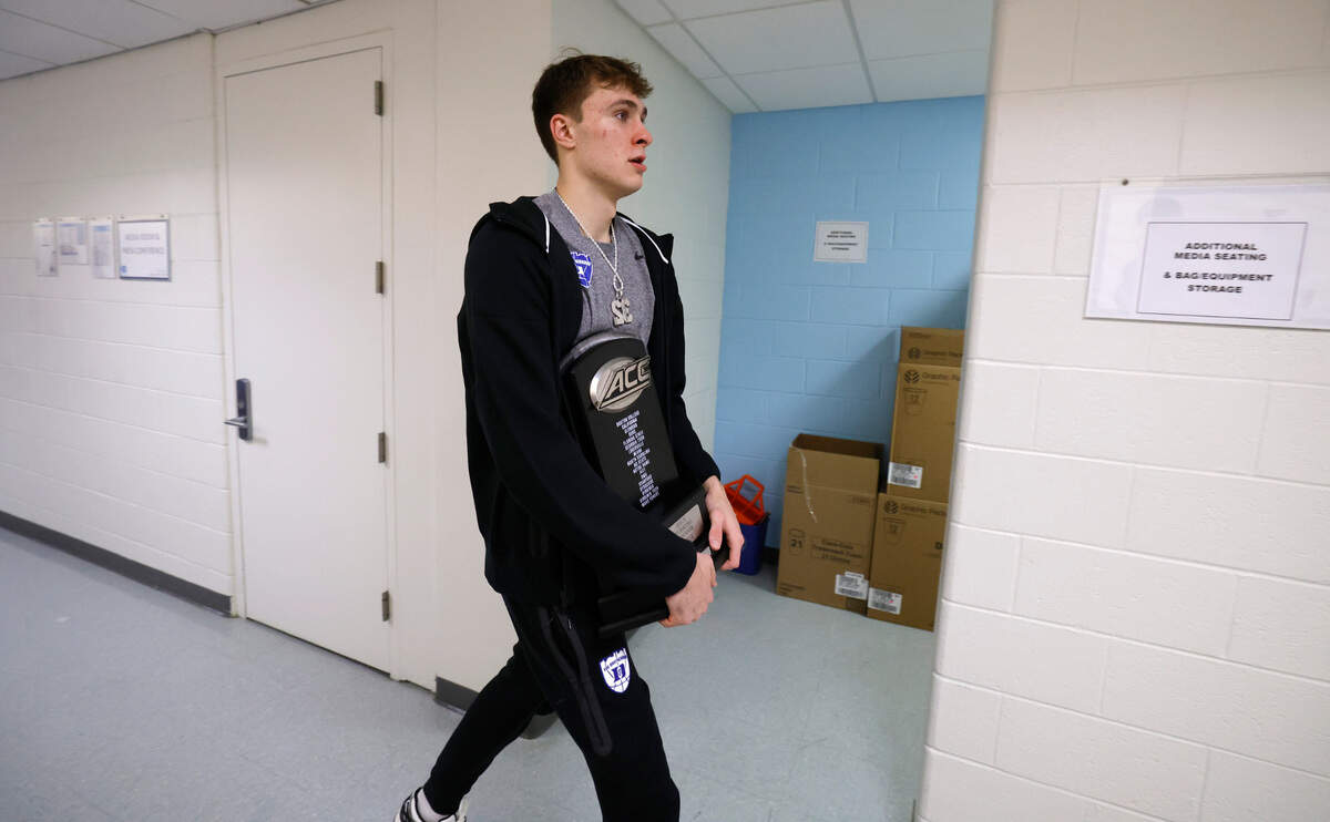 Duke’s Cooper Flagg heads to the bus with the ACC regular season championship trophy after Duke’s 82-69 victory over UNC at the Smith Center in Chapel Hill, N.C., Saturday, March 8, 2025.