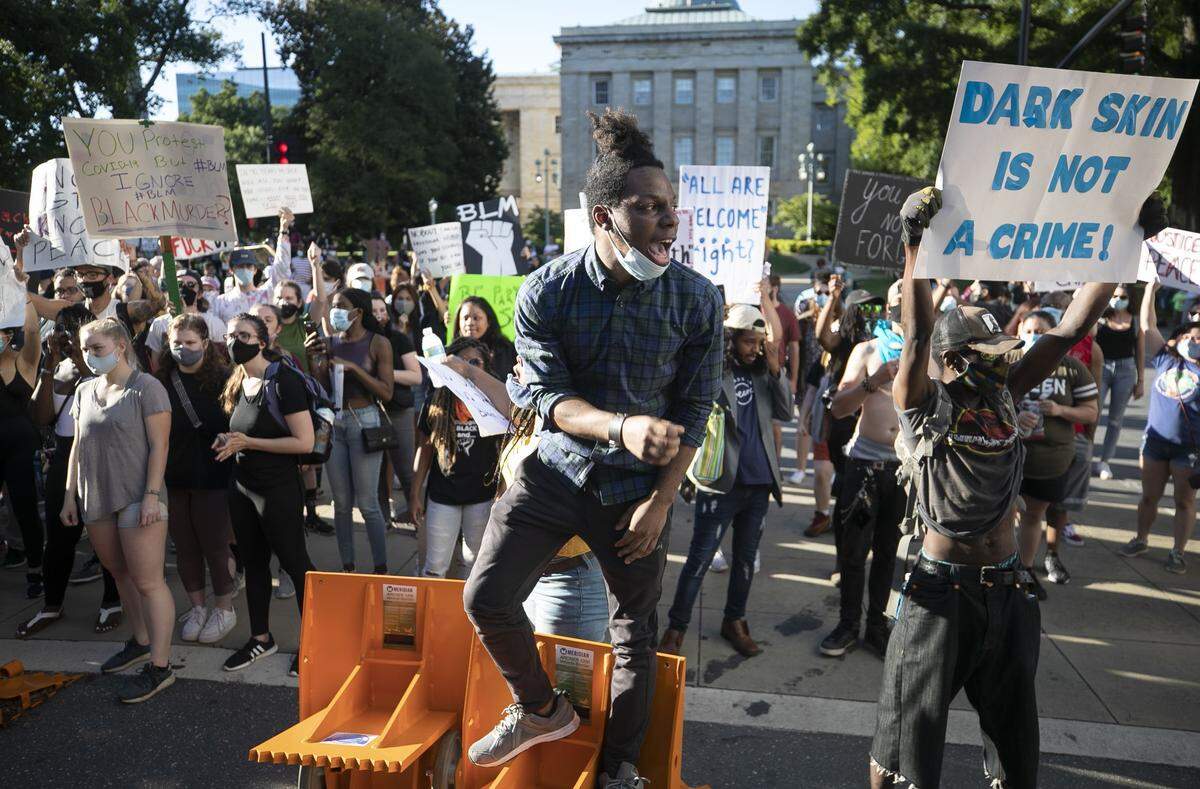 Protester blocked E. Morgan Street at the intersection with Fayetteville Street in front of the State Capitol as the second day of protest began on Sunday, May 31, 2020 in Raleigh, N.C. A crowd of protestors began gathering by late afternoon Sunday calling for justice in reaction to George Floyd’s death in Minneapolis, MN.