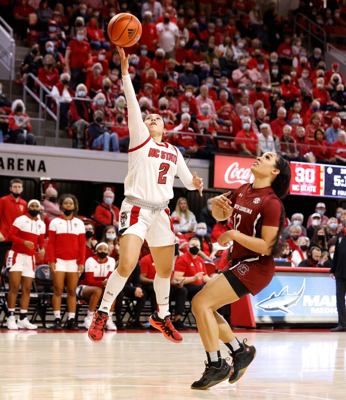 N.C. State’s Raina Perez (2) shoots as South Carolina’s Brea Beal (12) watches during the second half of South Carolinas 66-57 victory over N.C. State at Reynolds Coliseum in Raleigh, N.C., Tuesday, November 9, 2021.